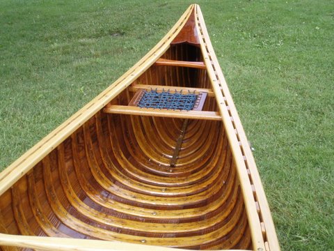 Restored wood and canvas canoes.