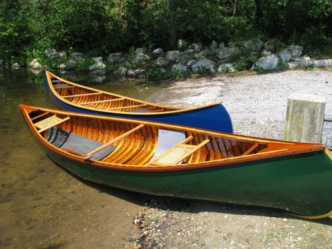 Restored wood and canvas canoes.